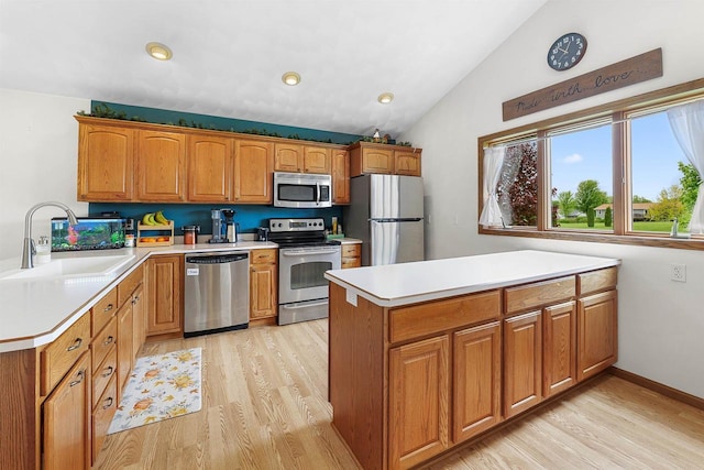 W9555 Zimmerman Dr, Beaver Dam, WI 53916 - kitchen with stainless steel appliances, a peninsula, a sink, light countertops, and light wood-style floors