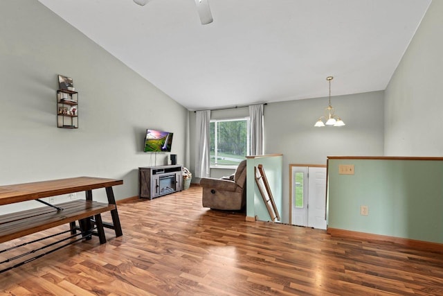 554 N Harvard Ave, Endeavor, WI 53930 - living area with wood finished floors, lofted ceiling, a chandelier, ceiling fan, and baseboards
