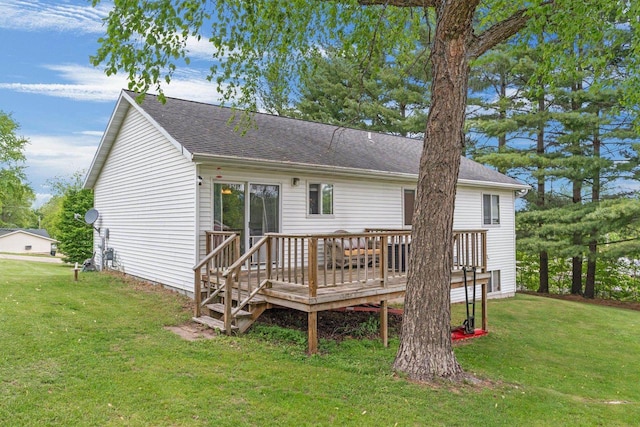 554 N Harvard Ave, Endeavor, WI 53930 - rear view of house with a wooden deck, a lawn, and a shingled roof