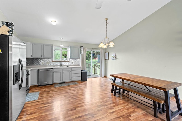554 N Harvard Ave, Endeavor, WI 53930 - kitchen with stainless steel appliances, gray cabinetry, tasteful backsplash, light wood-style flooring, and lofted ceiling