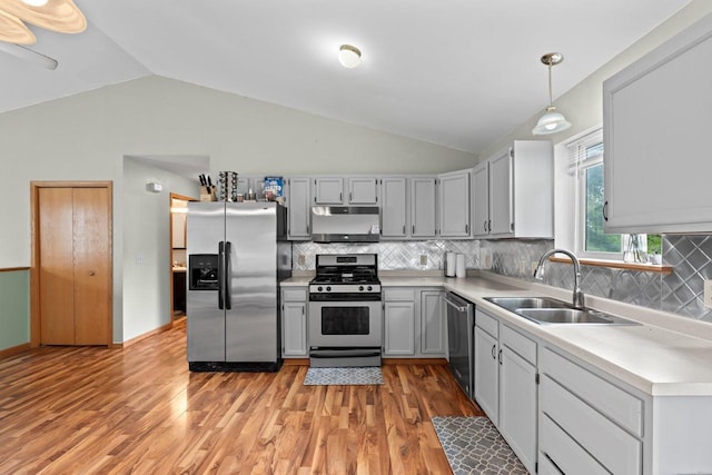 554 N Harvard Ave, Endeavor, WI 53930 - kitchen with appliances with stainless steel finishes, a sink, vaulted ceiling, under cabinet range hood, and light countertops