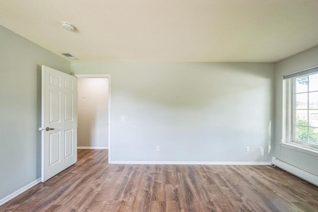 1402 Wheeler Rd Unit A, Madison, WI 53704 - empty room with a baseboard heating unit, wood finished floors, baseboards, and a smoke detector