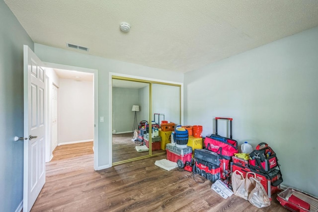 1402 Wheeler Rd Unit A, Madison, WI 53704 - game room with wood finished floors, baseboards, and a textured ceiling
