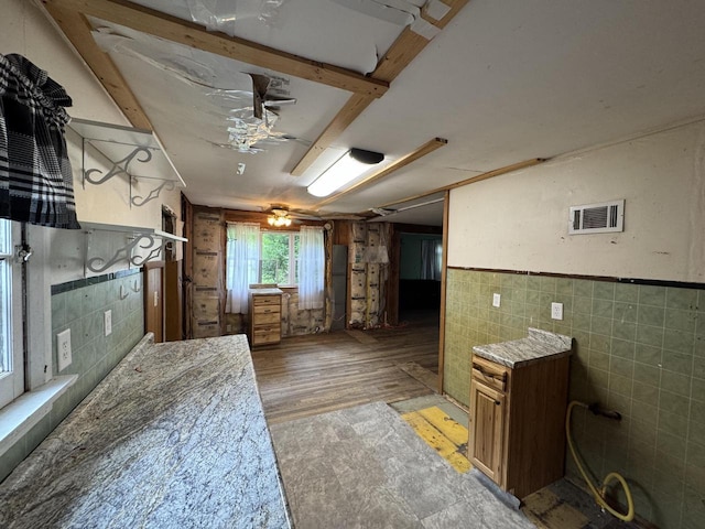 8444 Fish Hatchery Rd, Burlington, WI 53105 - bathroom with tile walls, a ceiling fan, and a wainscoted wall