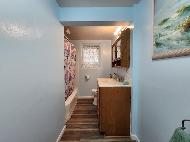 1130 10th St S, Wisconsin Rapids, WI 54494 - full bath with baseboards, vanity, toilet, wood finished floors, and shower / tub combo with curtain
