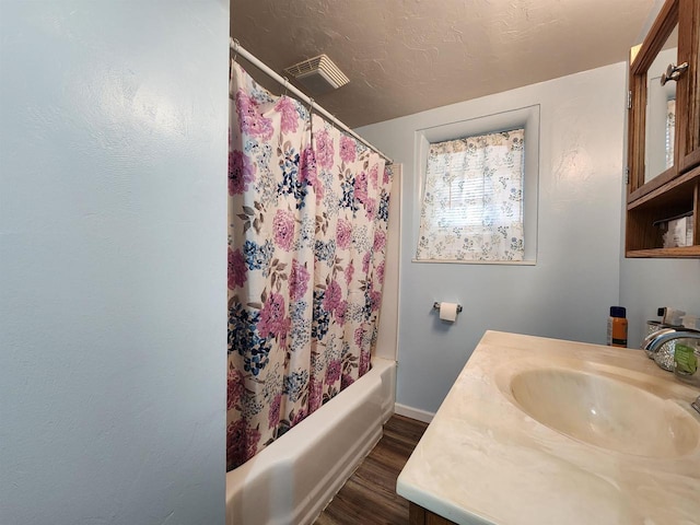 1130 10th St S, Wisconsin Rapids, WI 54494 - bathroom with wood finished floors, vanity, shower / bathtub combination with curtain, and baseboards