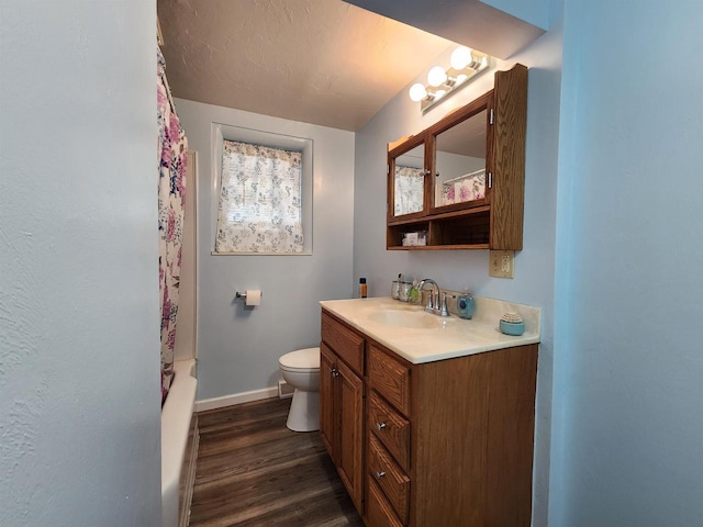 1130 10th St S, Wisconsin Rapids, WI 54494 - bathroom featuring vanity, baseboards, toilet, wood finished floors, and shower / tub combo with curtain