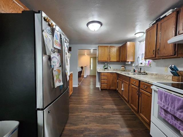 1130 10th St S, Wisconsin Rapids, WI 54494 - kitchen featuring freestanding refrigerator, white range with electric cooktop, a sink, brown cabinetry, and light countertops