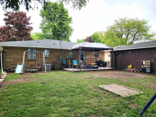 1130 10th St S, Wisconsin Rapids, WI 54494 - rear view of house featuring a lawn, a patio area, central AC unit, and stone siding