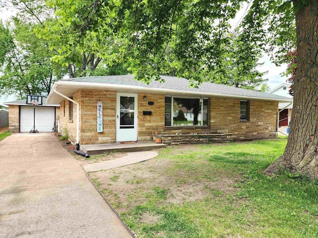 1130 10th St S, Wisconsin Rapids, WI 54494 - ranch-style house featuring concrete driveway, a front yard, and stone siding