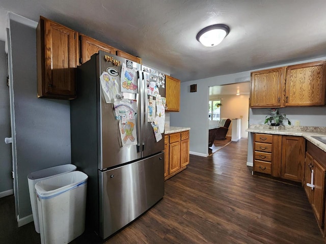 1130 10th St S, Wisconsin Rapids, WI 54494 - kitchen featuring freestanding refrigerator, dark wood-type flooring, brown cabinets, and light countertops