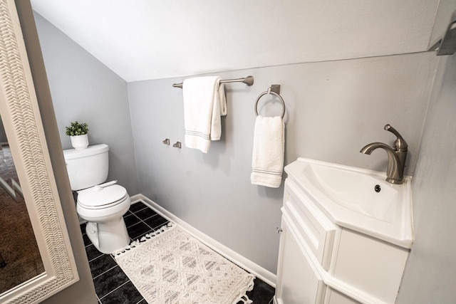 640 Crystal Ln, Elm Grove, WI 53122 - bathroom featuring toilet, lofted ceiling, vanity, tile patterned floors, and baseboards