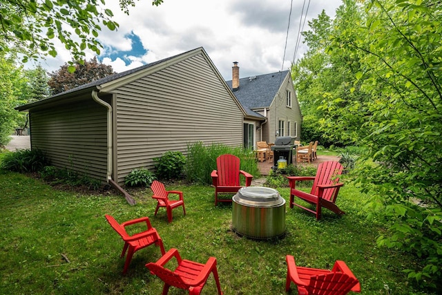 640 Crystal Ln, Elm Grove, WI 53122 - view of green lawn featuring a fire pit and a patio