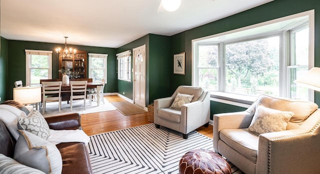 640 Crystal Ln, Elm Grove, WI 53122 - living room featuring a chandelier, wood finished floors, and baseboards