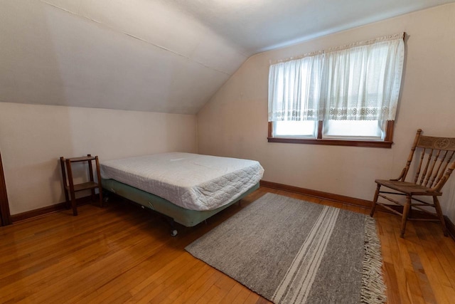 1816 Goodland Ave, Tomah, WI 54660 - bedroom featuring vaulted ceiling, wood-type flooring, and baseboards
