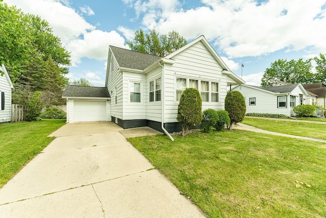 1816 Goodland Ave, Tomah, WI 54660 - bungalow-style house featuring a garage, a front lawn, concrete driveway, and a shingled roof