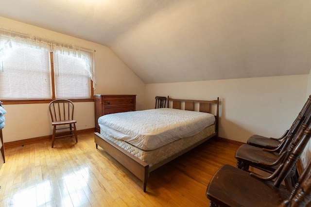 1816 Goodland Ave, Tomah, WI 54660 - bedroom with light wood-type flooring, vaulted ceiling, and baseboards