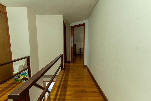 1816 Goodland Ave, Tomah, WI 54660 - hallway featuring an upstairs landing, wood finished floors, and baseboards