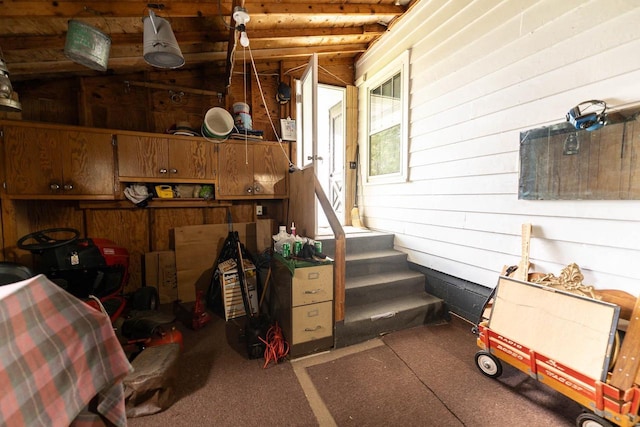 1816 Goodland Ave, Tomah, WI 54660 - interior space featuring wooden walls, carpet, and stairway