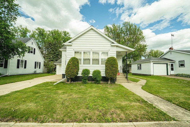 1816 Goodland Ave, Tomah, WI 54660 - bungalow-style home with an outdoor structure, a front yard, and driveway