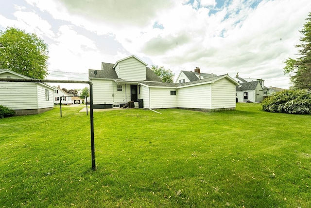 1816 Goodland Ave, Tomah, WI 54660 - back of property featuring a yard and roof with shingles