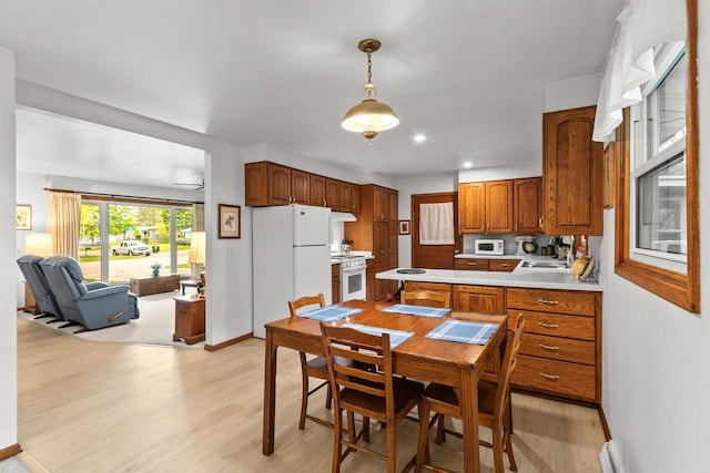 404 W Albert St, Portage, WI 53901 - kitchen with white appliances, light wood-style flooring, light countertops, a sink, and recessed lighting