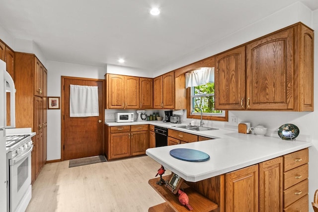 404 W Albert St, Portage, WI 53901 - kitchen with a sink, white appliances, open shelves, brown cabinetry, and light wood-type flooring