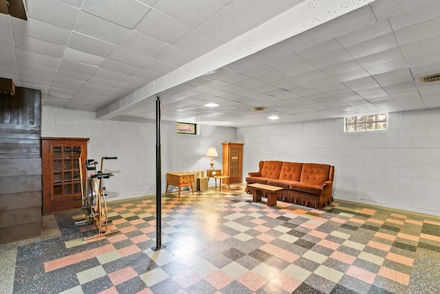404 W Albert St, Portage, WI 53901 - below grade area featuring tile patterned floors, concrete block wall, and a paneled ceiling