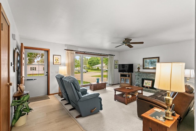 404 W Albert St, Portage, WI 53901 - living area with healthy amount of natural light, ceiling fan, a fireplace, and light wood finished floors
