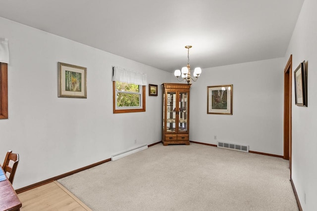 404 W Albert St, Portage, WI 53901 - unfurnished dining area with a baseboard radiator, a chandelier, and baseboards