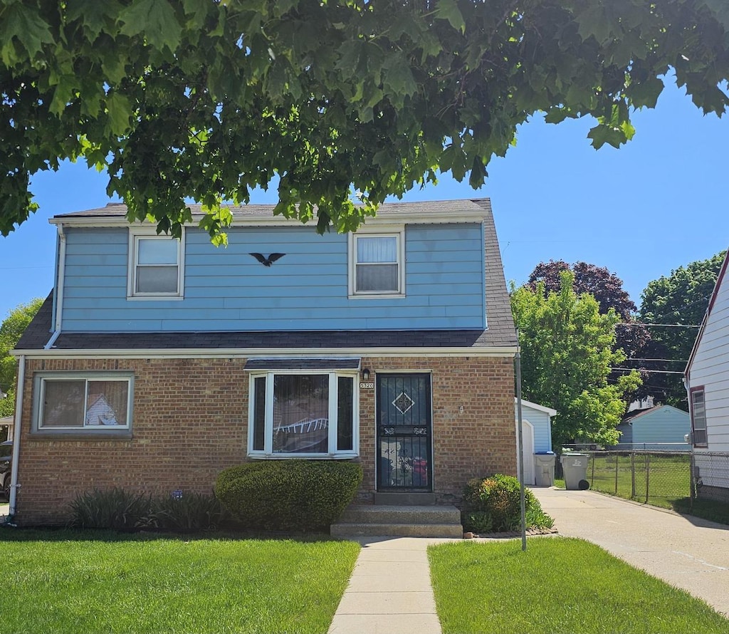 5320 N 60th St, Milwaukee, WI 53218 - traditional-style home with brick siding and a shingled roof