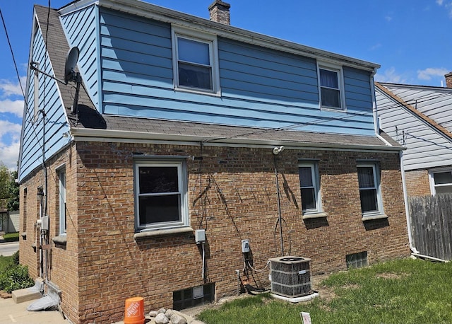 5320 N 60th St, Milwaukee, WI 53218 - view of side of home featuring cooling unit, brick siding, and a chimney