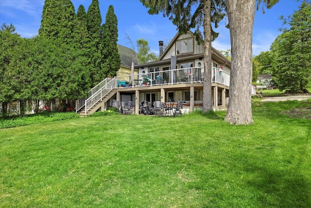 N26W30255 Maple Ave, Pewaukee, WI 53072 - back of property featuring a lawn, a deck, stairway, and a patio