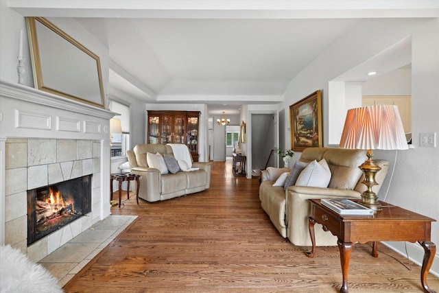 N26W30255 Maple Ave, Pewaukee, WI 53072 - living room with wood finished floors, a fireplace, and a chandelier