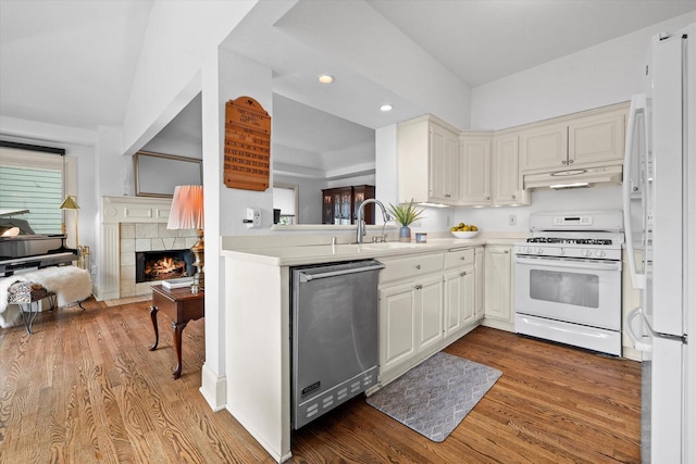 N26W30255 Maple Ave, Pewaukee, WI 53072 - kitchen with white appliances, under cabinet range hood, a sink, wood finished floors, and recessed lighting