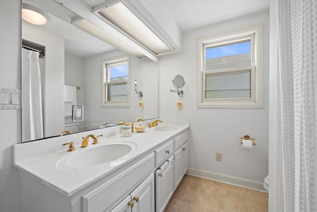 N26W30255 Maple Ave, Pewaukee, WI 53072 - full bathroom featuring double vanity, baseboards, toilet, and tile patterned flooring