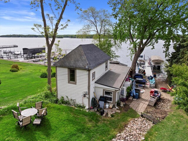 N26W30255 Maple Ave, Pewaukee, WI 53072 - rear view of house featuring a water view, a shingled roof, and a yard