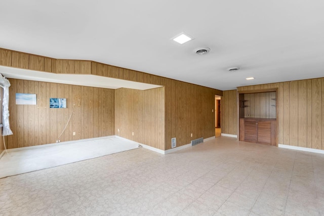 4998 Sterling Dr, Greendale, WI 53129 - unfurnished room featuring tile patterned floors, wood walls, and baseboards