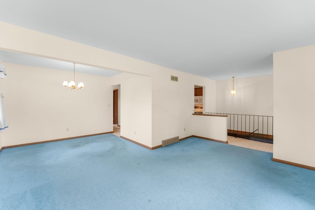 4998 Sterling Dr, Greendale, WI 53129 - empty room featuring a chandelier, light colored carpet, and baseboards