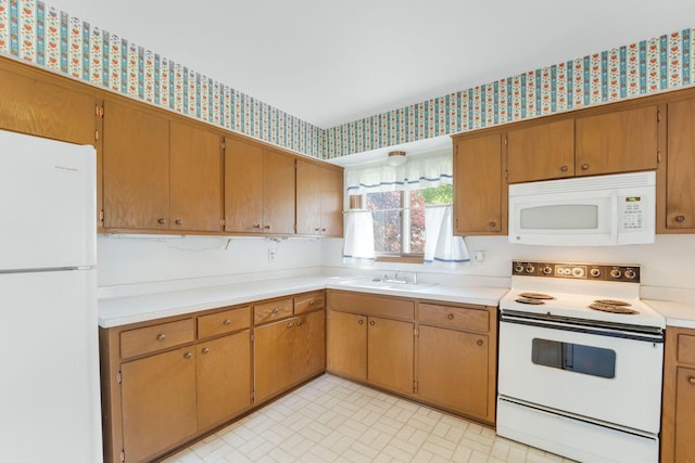 4998 Sterling Dr, Greendale, WI 53129 - kitchen featuring white appliances, wallpapered walls, a sink, light countertops, and brick patterned flooring