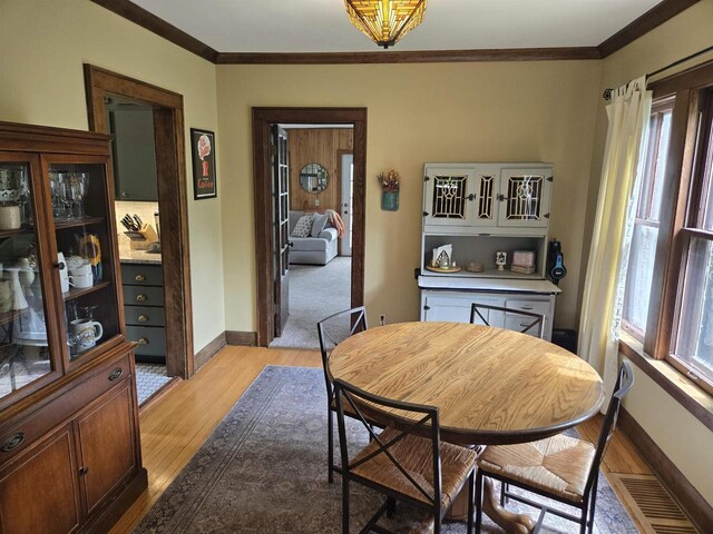 3609 Gregory St, Madison, WI 53711 - dining space featuring ornamental molding, light wood-style flooring, baseboards, and plenty of natural light