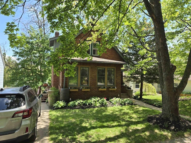 3609 Gregory St, Madison, WI 53711 - view of front of house featuring brick siding, a front lawn, and a chimney