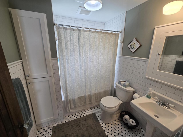 3609 Gregory St, Madison, WI 53711 - bathroom featuring tile walls, a wainscoted wall, toilet, shower / bath combination with curtain, and a sink