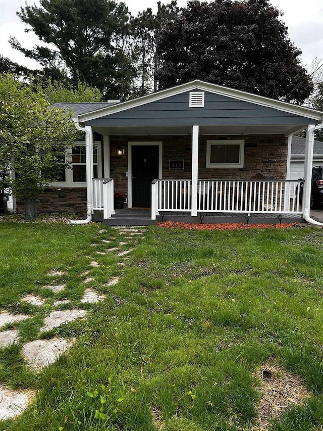 433 Rachael Rd, Baraboo, WI 53913 - view of front of home featuring stone siding, a porch, and a front lawn