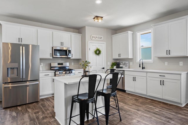 972 Margarets Way, Belleville, WI 53508 - kitchen featuring appliances with stainless steel finishes, a sink, dark wood-style floors, white cabinetry, and recessed lighting