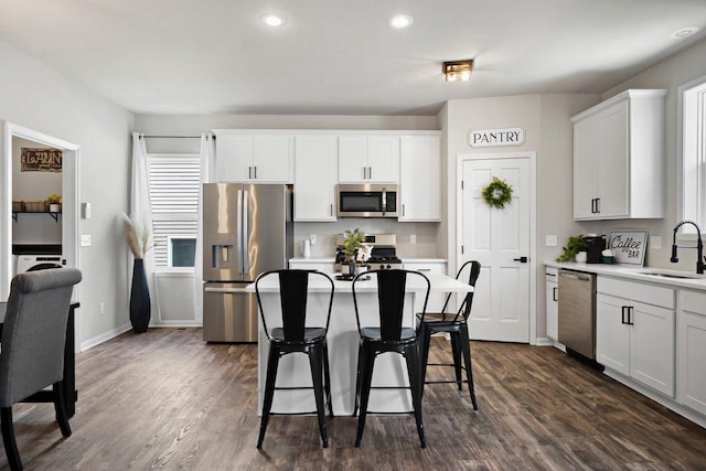 972 Margarets Way, Belleville, WI 53508 - kitchen with stainless steel appliances, a sink, a kitchen bar, dark wood-style flooring, and recessed lighting