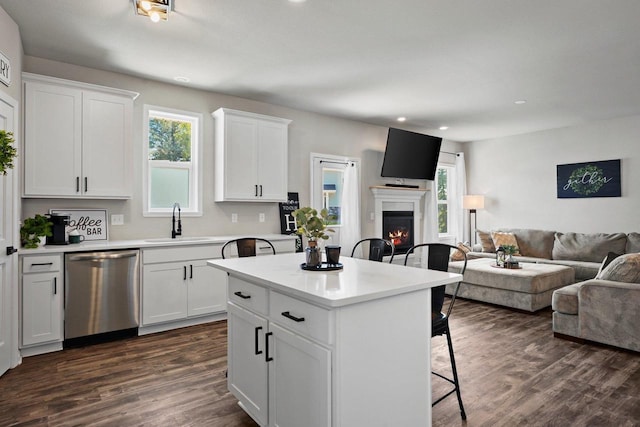 972 Margarets Way, Belleville, WI 53508 - kitchen featuring stainless steel dishwasher, a sink, a kitchen breakfast bar, open floor plan, and recessed lighting