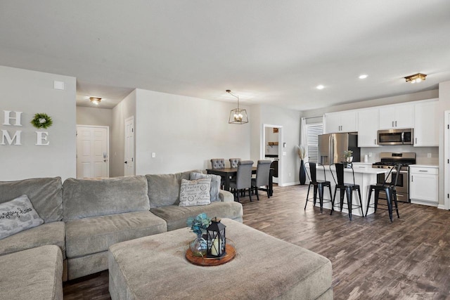 972 Margarets Way, Belleville, WI 53508 - living area featuring dark wood-style flooring, recessed lighting, baseboards, and a chandelier
