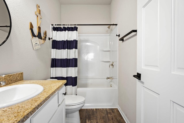 972 Margarets Way, Belleville, WI 53508 - full bathroom featuring wood finished floors, vanity, toilet, shower / bathtub combination with curtain, and baseboards
