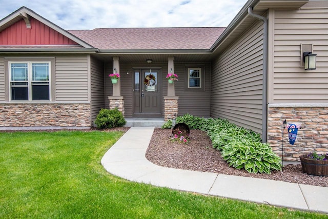 N7984 Woody Ln, Ixonia, WI 53036 - entrance to property with stone siding, a lawn, and board and batten siding